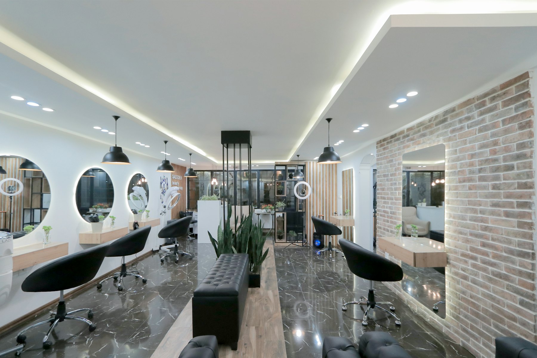 Salon mit Spiegeln und Backsteinwand